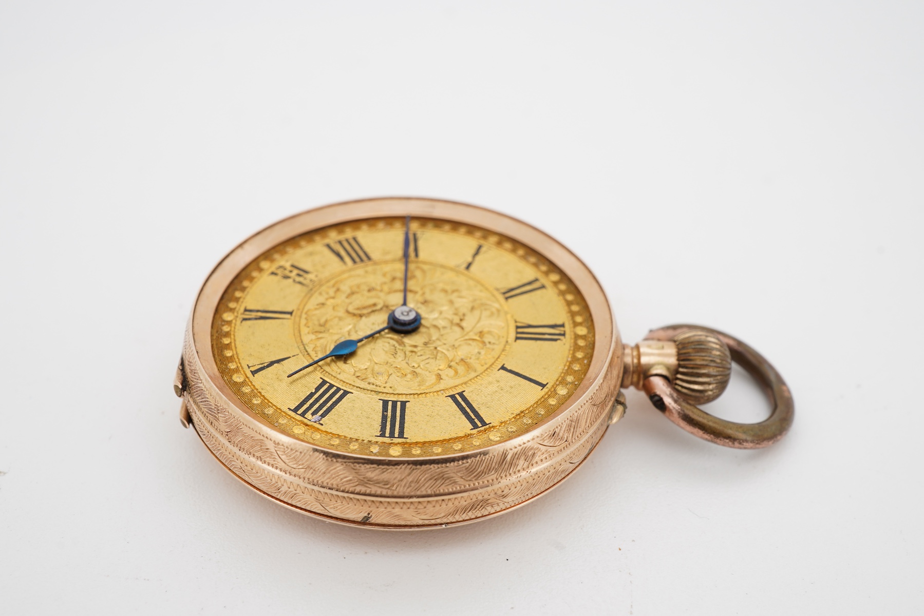 A lady's late 19th century Swiss engraved 14k keyless open faced fob watch, lacking glass, case diameter 32mm, with gilt metal inner cuvette, gross weight 27.6 grams.